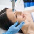 Close up of doctor cosmetologist performing facial skincare procedure with cleansing microdermabrasion hydro device