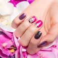 Beautiful colorful manicure with bubbles and crystals on female hand. Close-up. Picture taken in the studio